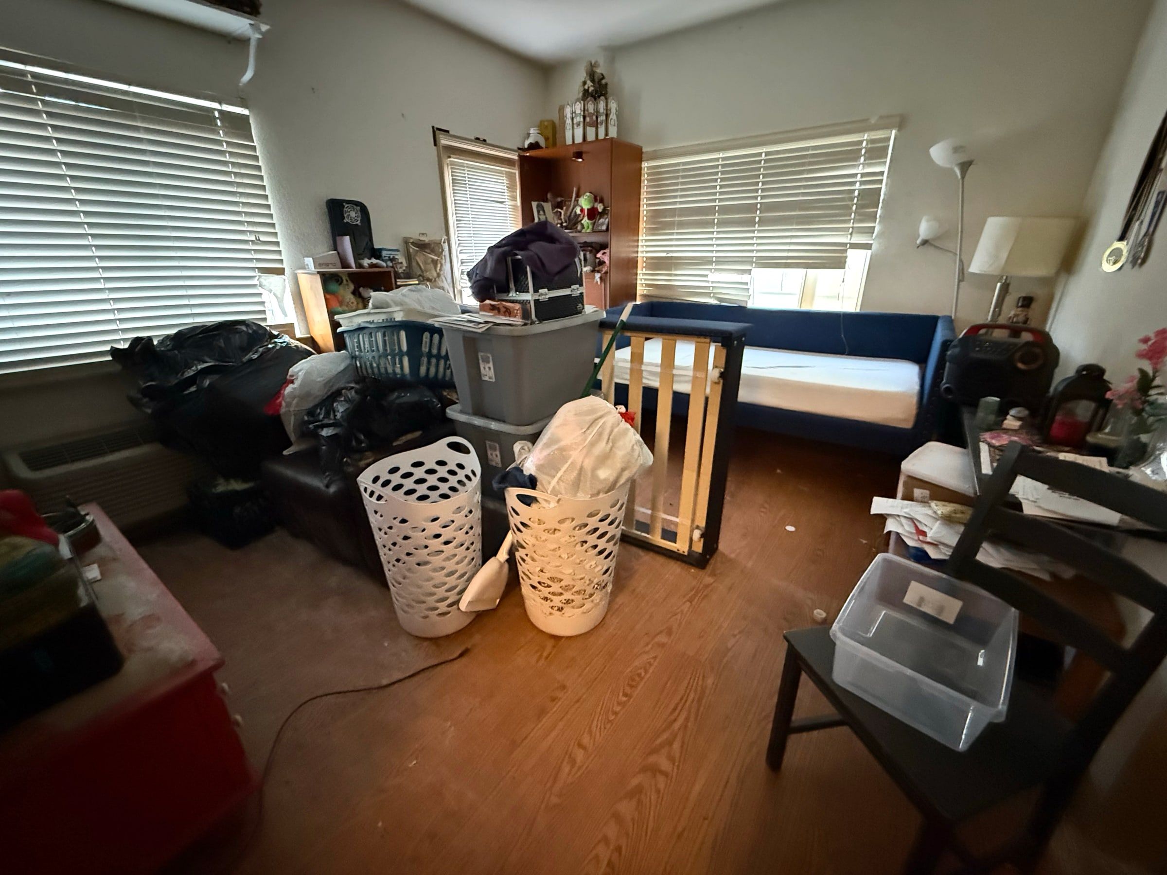 Before: Spare room crowded with baskets, boxes and equipment