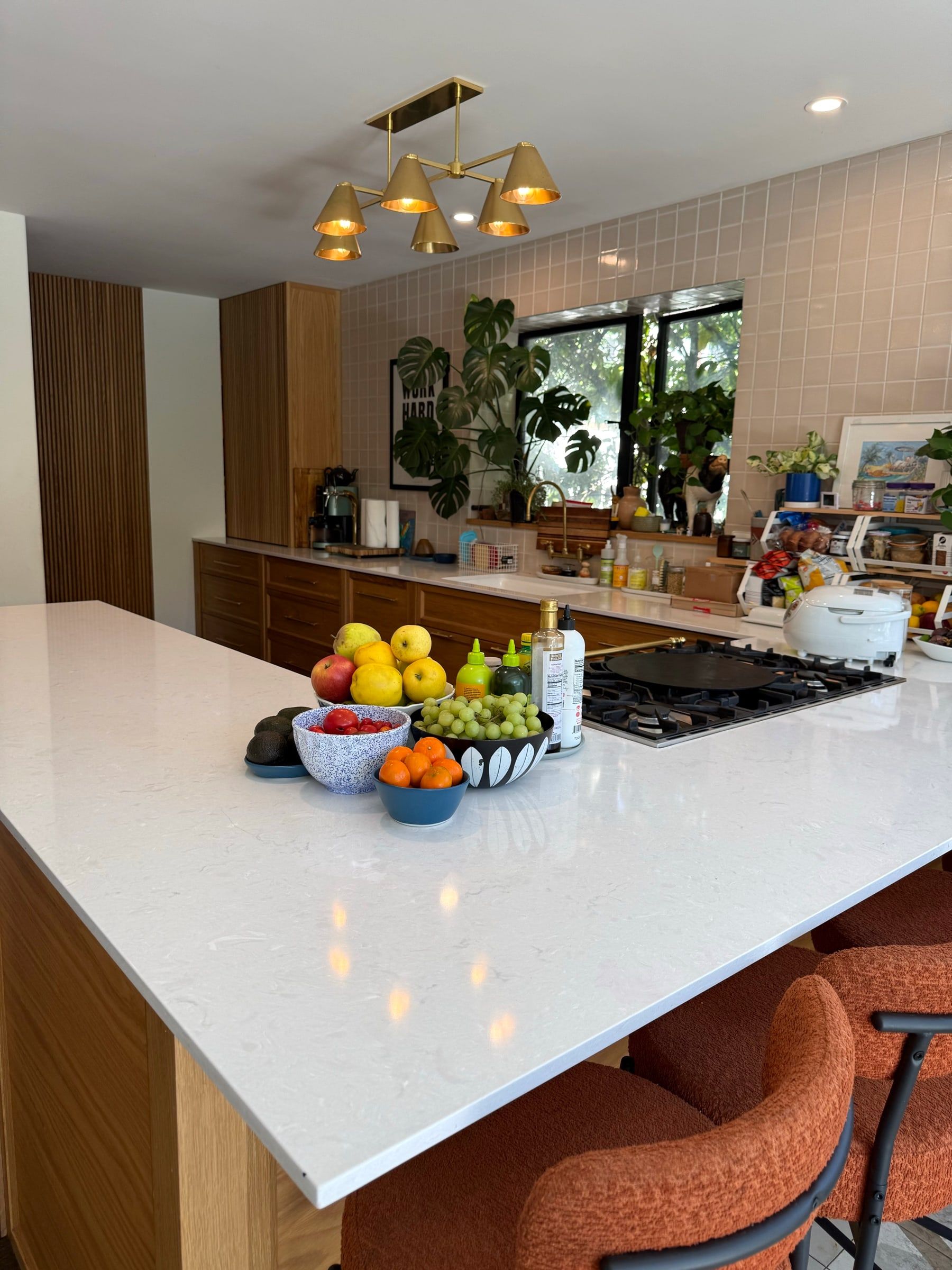 After: The same kitchen island cleared and wiped clean, with only a fruit bowl left