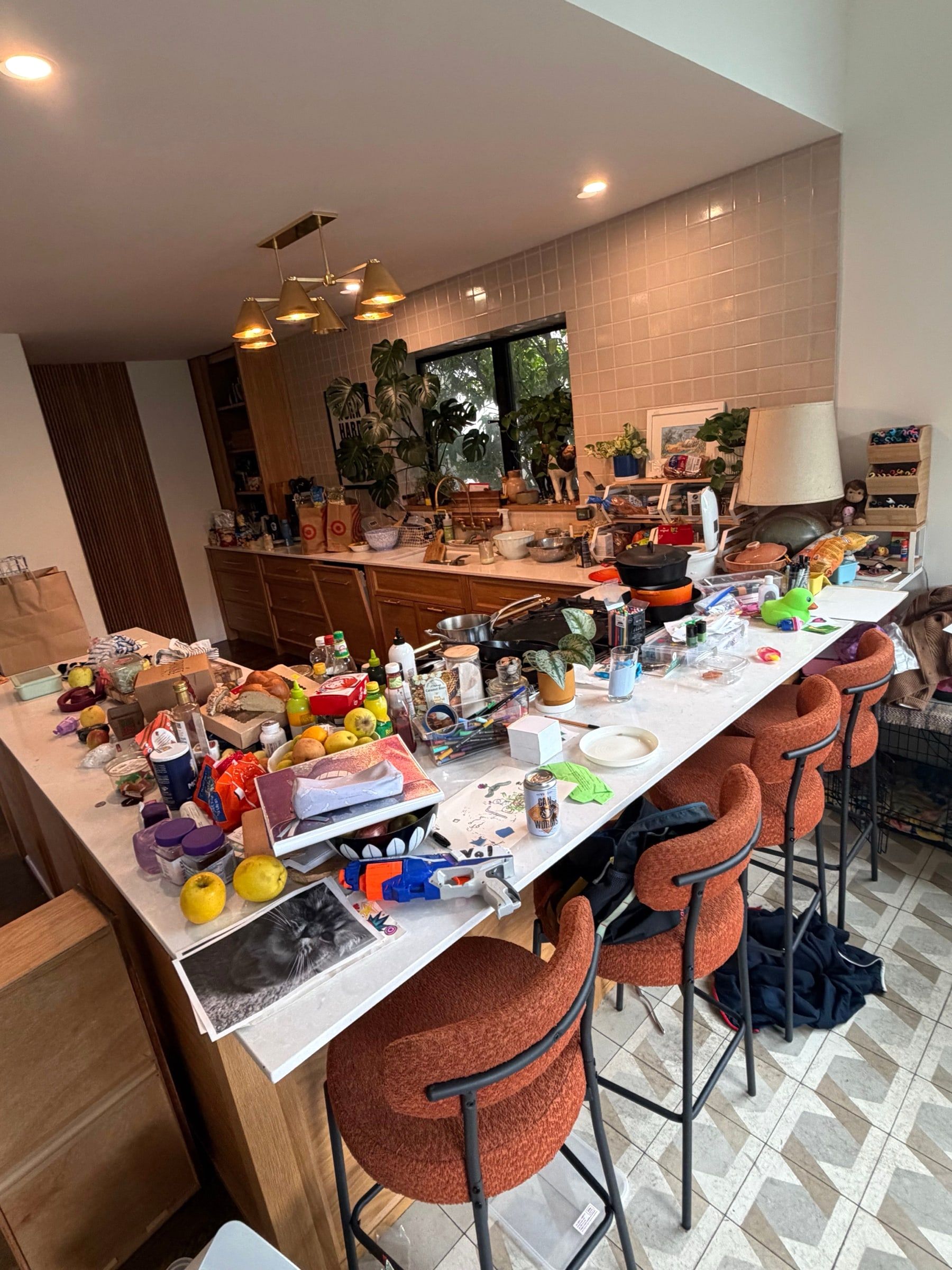 Before: Kitchen island covered in groceries, dishes and clutter before cleaning