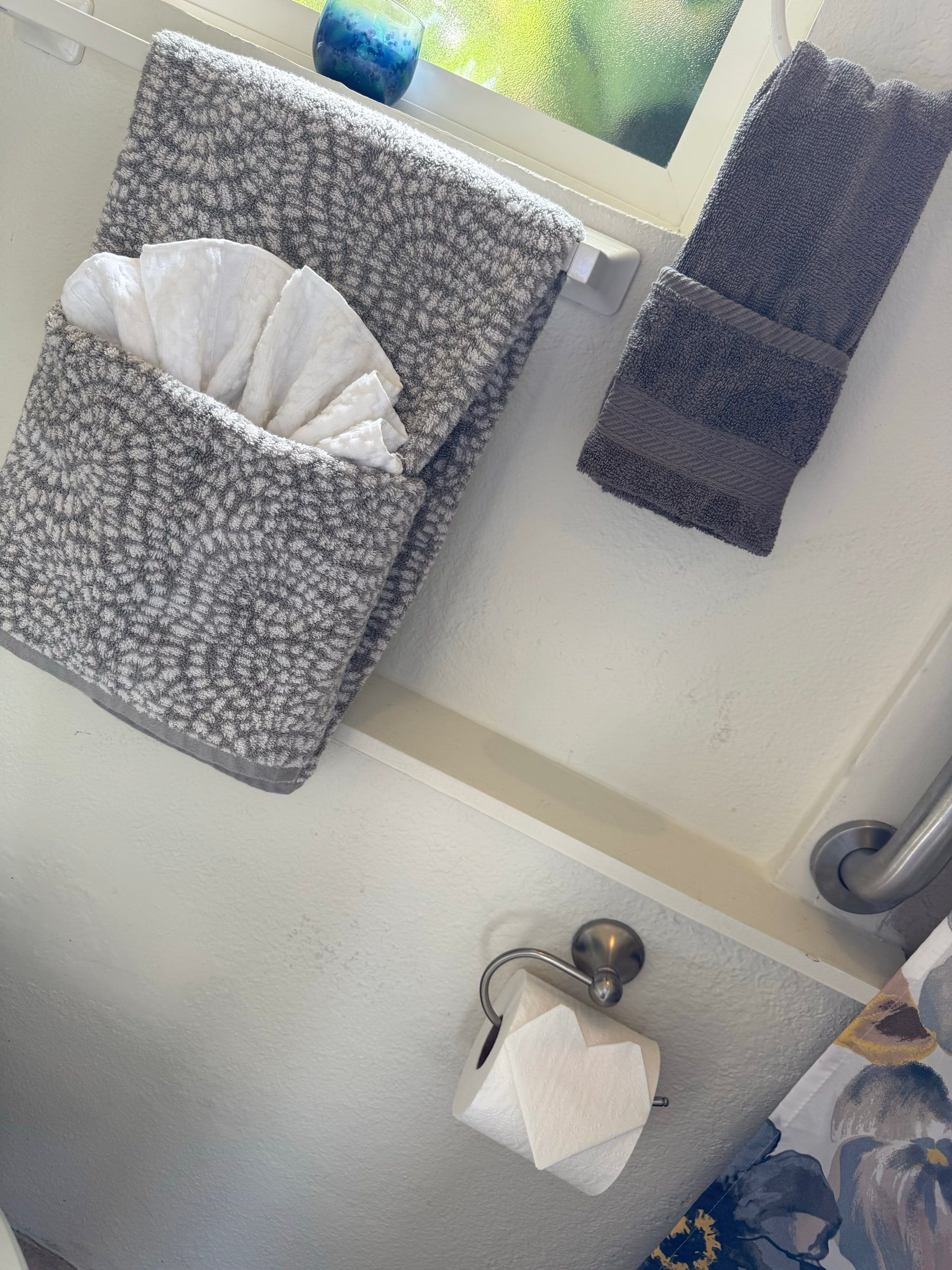 Bathroom towels folded and hung neatly after a regular cleaning