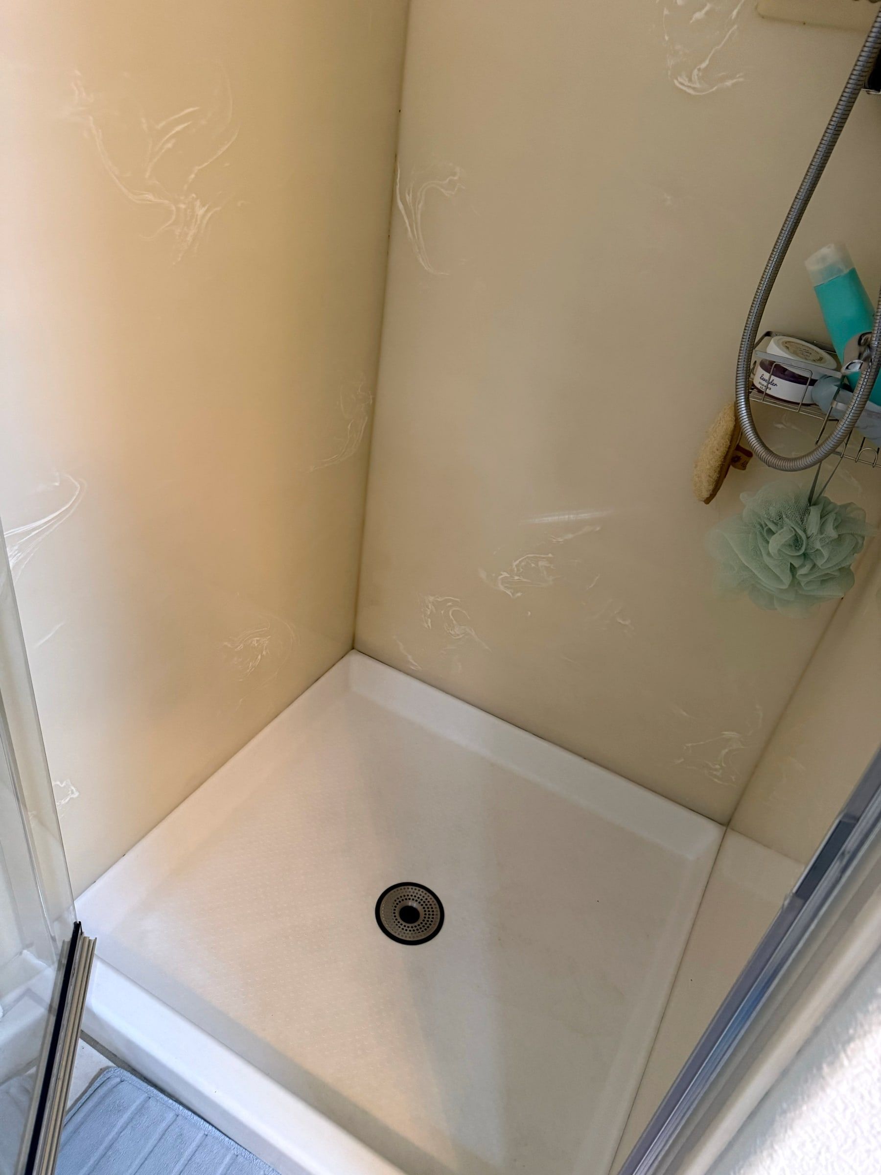 After: The same shower base bright white after deep cleaning